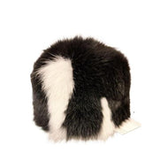 A round black and white fox fur unisex cap with the lining on a white background.