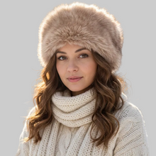 Įkelti nuotrauką į galerijos peržiūros programą, A woman wearing a beige faux fur hat and a cream cable-knit turtleneck sweater, photographed against a solid light gray background.
