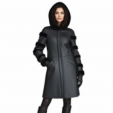 Įkelti nuotrauką į galerijos peržiūros programą, A model wearing a black hooded coat with textured paneling and black knee-high boots, photographed against a plain white background.

