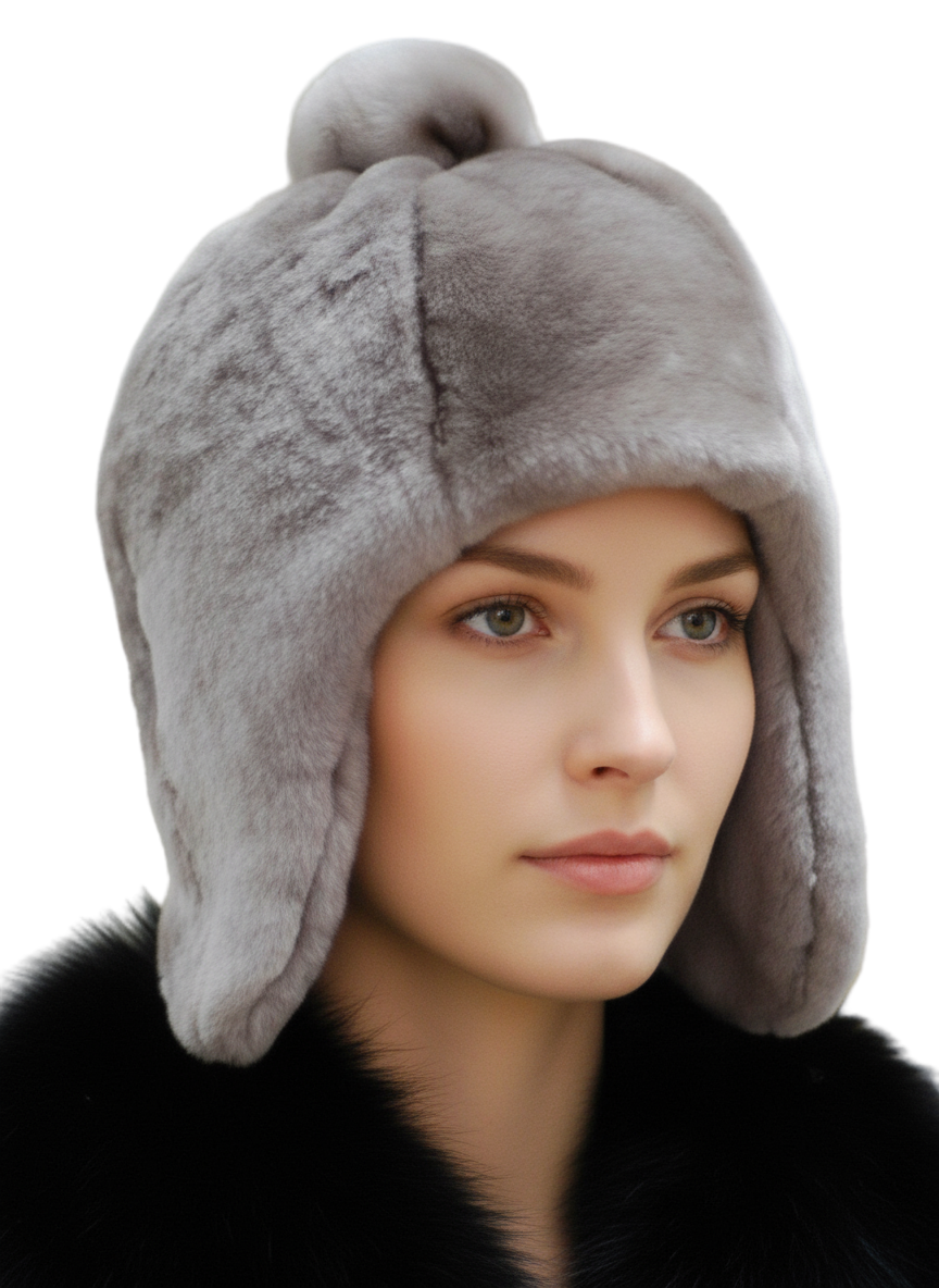 Woman wearing a gray fur hat with ear flaps against a neutral background