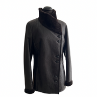 A dark brown sheepskin fur jacket with button details, notched lapels, and pockets on the front, displayed on a mannequin.