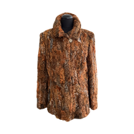 A brown Astrakhan fur short jacket with pockets at the front and fur hooks fastening, displayed on a mannequin.