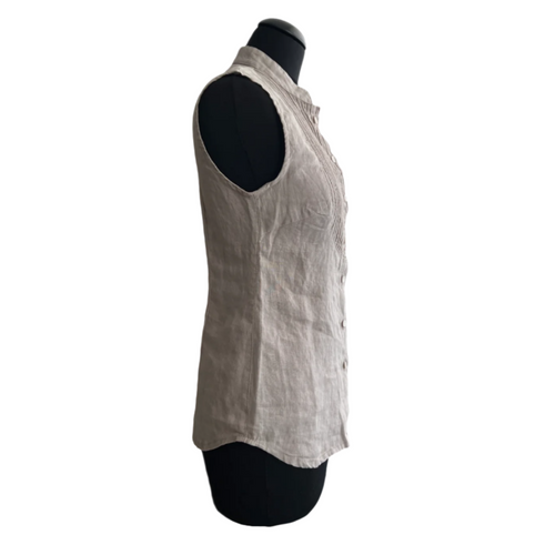 A sleeveless, buttoned, gray linen blouse displayed on a mannequin, with decorative seams and a slightly transparent fabric.