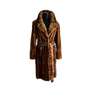 Brown knee-length mink jacket with a wide collar, fur hooks fastening, and front pockets. It is displayed on a mannequin against a black background.