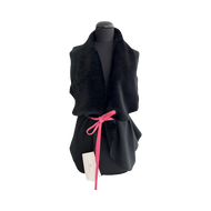 A black suede merino sheepskin loose fit vest with a pink tie on a mannequin.