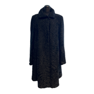 Black textured astrakhan fur coat on a mannequin against a white background