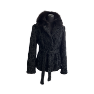 Black astrakhan (karakul) hip-length jacket with black dyed Bluefox collar and fur hooks fastening. Pockets are visible at the front, and there is a tie at the waist.