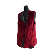 Red color sheared rabbit fur vest on a mannequin, featuring a zip fastening and a slightly loose fit.