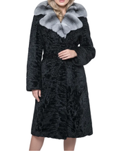 Įkelti nuotrauką į galerijos peržiūros programą, A woman wearing a long black textured fur coat with a wide light gray fur collar, photographed against a plain light gray studio background.
