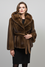Įkelti nuotrauką į galerijos peržiūros programą, A woman modeling a luxurious brown fur wrap jacket with a wide collar and matching belt, paired with a black skirt, against a solid gray studio background.

