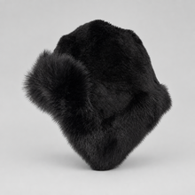 Įkelti nuotrauką į galerijos peržiūros programą, A black fur ushanka hat with a fluffy pom-pom ear warmer, photographed on a neutral light gray background.
