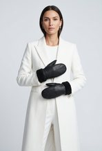 Įkelti nuotrauką į galerijos peržiūros programą, A woman modeling a long white coat and black mittens against a light gray studio background.

