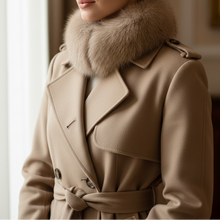 Įkelti nuotrauką į galerijos peržiūros programą, A woman wearing a beige trench coat with a thick light brown fur collar, posed indoors near a window.
