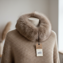 Įkelti nuotrauką į galerijos peržiūros programą, A beige chunky knit sweater with a large taupe-brown faux fur collar, displayed on a mannequin in a softly lit room.
