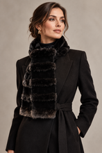 Įkelti nuotrauką į galerijos peržiūros programą, A woman wearing a black coat and a dark brown and black faux fur scarf, photographed against a neutral gray studio background.

