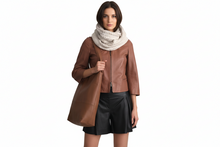 Load image into Gallery viewer, Woman wearing a brown leather jacket and black shorts with a beige scarf on a white background
