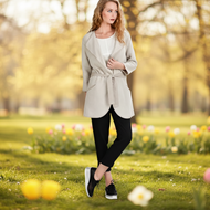 Woman walking in a park with flowers and trees in the background