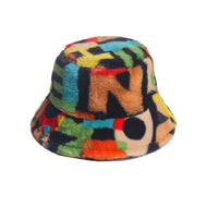 A multicolour artificial fur bucket cap with a letters pattern, featuring a cinnamon brown colour, adjustable size