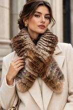 Load image into Gallery viewer, A woman wearing a luxurious, thick faux-fur scarf in mixed brown, beige, and gray tones, styled with a cream-colored coat.
