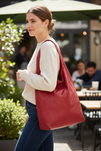 Load image into Gallery viewer, Woman holding a red bag in an outdoor setting
