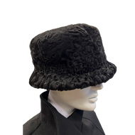 A black astrakhan fur hat displayed on a mannequin head.