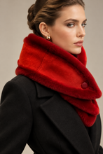 Load image into Gallery viewer, A close-up of a woman wearing a vibrant red faux-fur scarf with a single button closure and a black coat, set against a neutral beige background.
