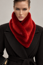 Load image into Gallery viewer, A close-up of a model wearing a luxurious bright red faux fur cowl neck warmer over a black coat, set against a neutral gray studio background.
