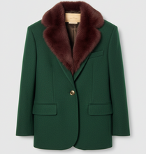 Įkelti nuotrauką į galerijos peržiūros programą, A dark green wool blazer with a luxurious dark brown fur collar, featuring a single gold button and two front flap pockets, displayed on a hanger against a light gray background.
