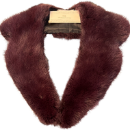 A deep burgundy mink collar with a fur hook fastening displayed on a flat surface.
