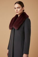 Įkelti nuotrauką į galerijos peržiūros programą, A woman wearing a dark charcoal gray coat with a large, luxurious deep burgundy fur collar, posed against a solid warm beige background.
