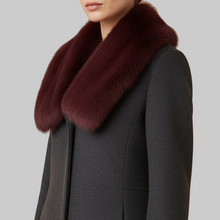 Įkelti nuotrauką į galerijos peržiūros programą, A close-up of a model wearing a dark charcoal gray coat with a large, luxurious deep burgundy fur collar, set against a solid warm beige background.
