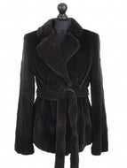 A mahogany dark brown sheared mink jacket with a tie, fur hook fastening, and pockets at the front, displayed on a mannequin.