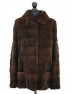 Brown sheared mink jacket with a stand collar, front pockets, and fur hooks fastening, displayed on a mannequin.