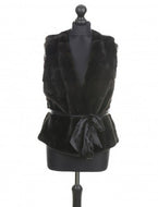 A brown mink fur vest with a silk belt on a mannequin.