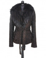A chocolate brown dyed astrakhan (karakul) hip-length jacket with a dyed brown raccoon collar, displayed on a mannequin.