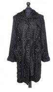 Black knee-length astrakhan coat with a tie, pockets at front, and fur hooks fastening. Lined inside with a deep vent at the back.
