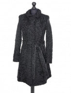 Black astrakhan knee-length coat with a tie, pockets at the front, and fur hooks fastening, displayed on a mannequin.