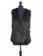 Black rabbit fur vest on a mannequin, featuring a silk ribbon fastening and interlining inside for structure.