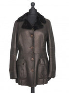 A dark brown leather jacket with black sheepskin fur collar and cuffs, featuring a V-neck, notched lapels, and front pockets.