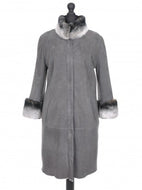 A gray knee-length suede sheepskin fur coat with turtleneck collar and front pockets, featuring 3/4 length sleeves and chinchilla trimmings.