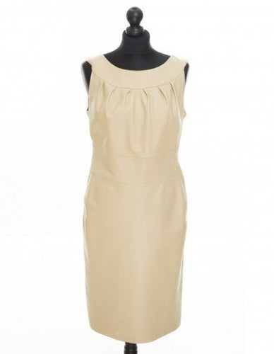 Beige color, sleeveless, fitted midi length dress with a round neckline and an invisible zipper in the back, displayed on a mannequin.