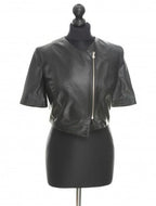 Black sheep leather mini jacket with short sleeves and a front zip, displayed on a mannequin.