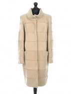 Beige long sheepskin fur coat with decorative textile inserts, featuring a stand collar, front pockets, and lining inside.