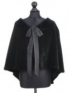 A black merino sheepskin fur cloak displayed on a mannequin, featuring a silk tie fastening and lining inside.