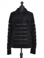 Black sheepskin fur short jacket with textile inserts and a fur hooks fastening, displayed on a mannequin.