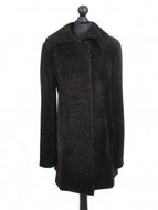 Dark chocolate brown knee length sheepskin fur coat displayed on a mannequin with a regular collar, front pockets, and lining visible.