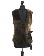 A dark brown sheepskin fur vest with goldening tipping, displayed on a mannequin.
