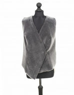 Grey reversible suede merino sheepskin fur vest displayed on a mannequin with a fitted silhouette and open front design.