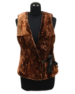 A dark brown sheepskin fur vest with goldening tipping, displayed on a mannequin.