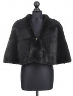 A dark brown mahogany-colored rabbit fur cloak with a free silhouette, displayed on a mannequin. It features a lining inside and fur hook fastening.